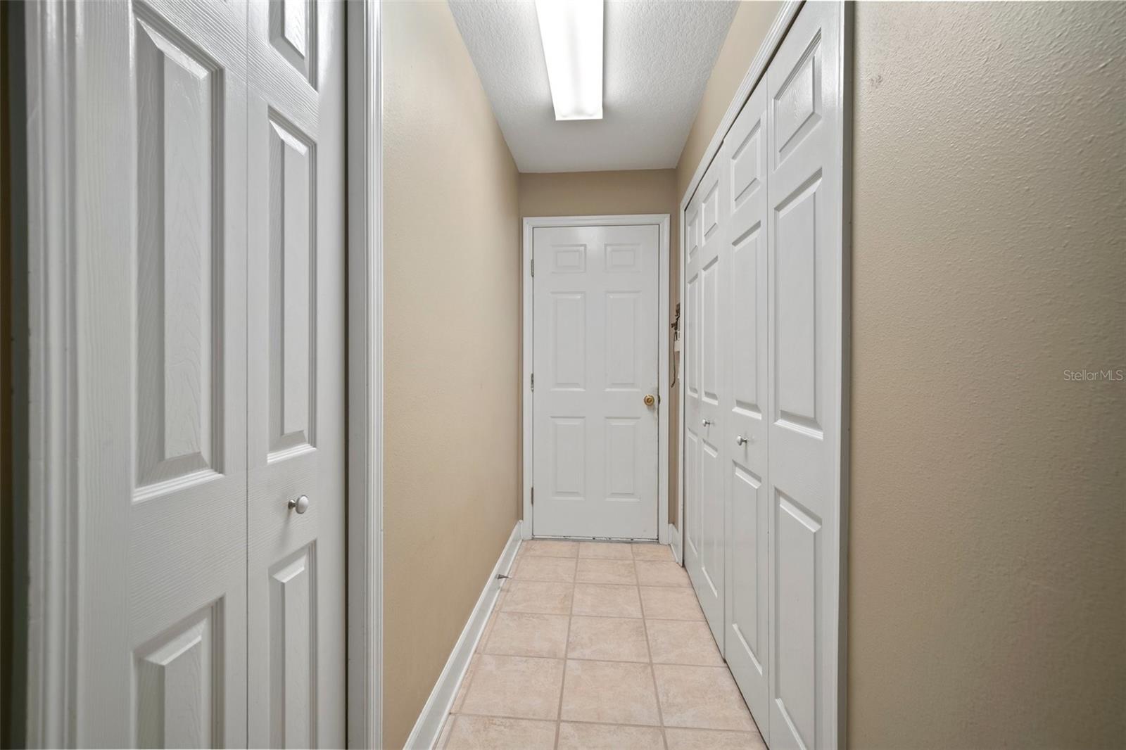 Interior laundry room with under stair storage and extra storage closet