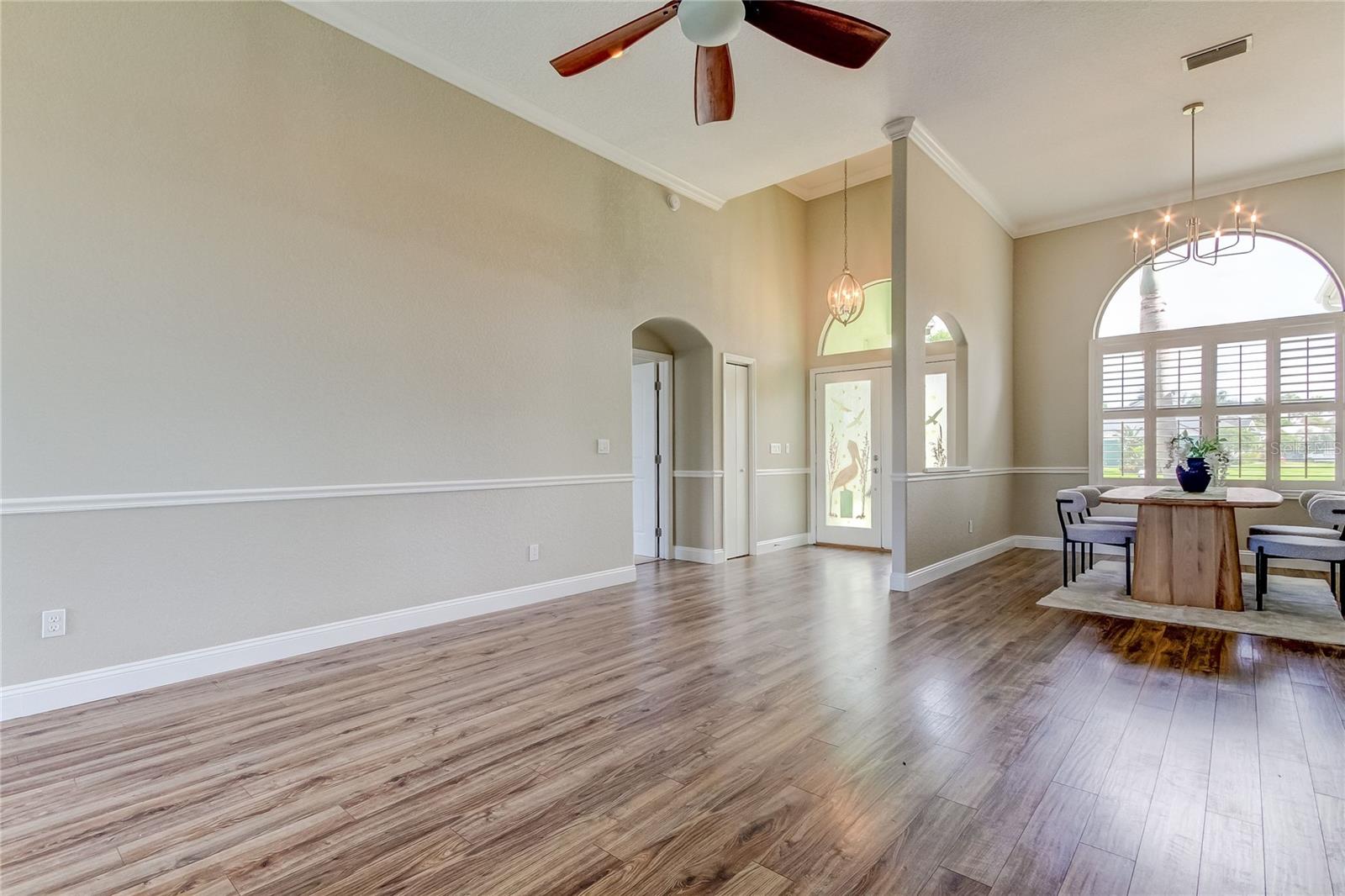 Front door/dining. Door on left leads into Primary Bedroom suite.