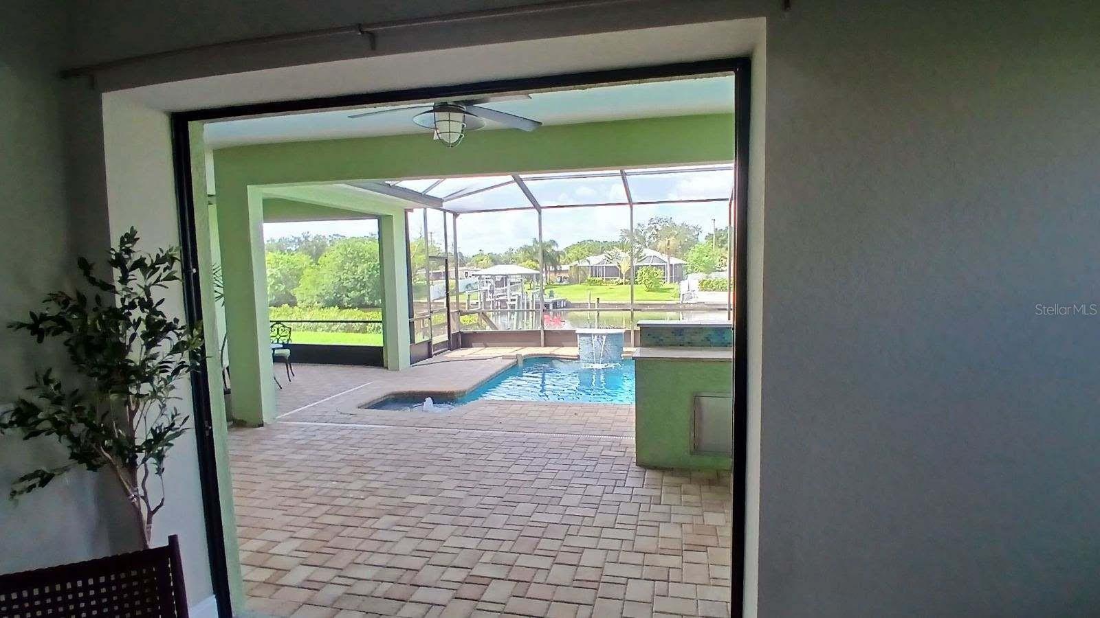 Owner's suite sliders open fully to provide a wide open view of the pool and canal!