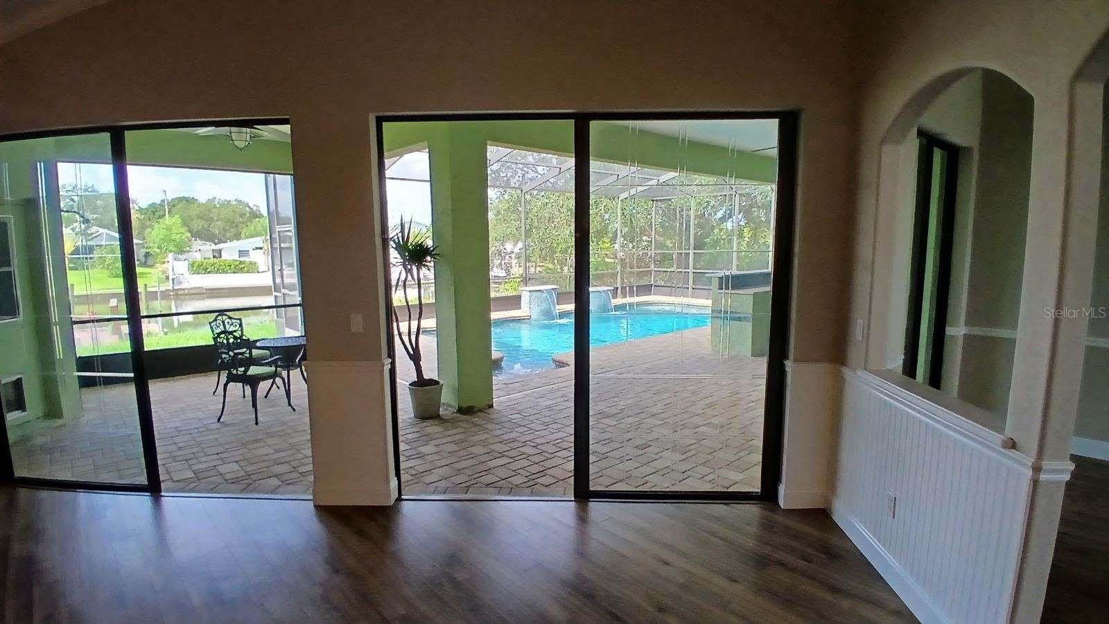 Living room sliders open to the pool area.