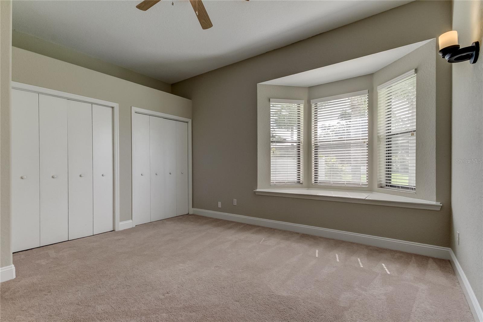 Bedroom 3 with storage under the windows, and dual closets.