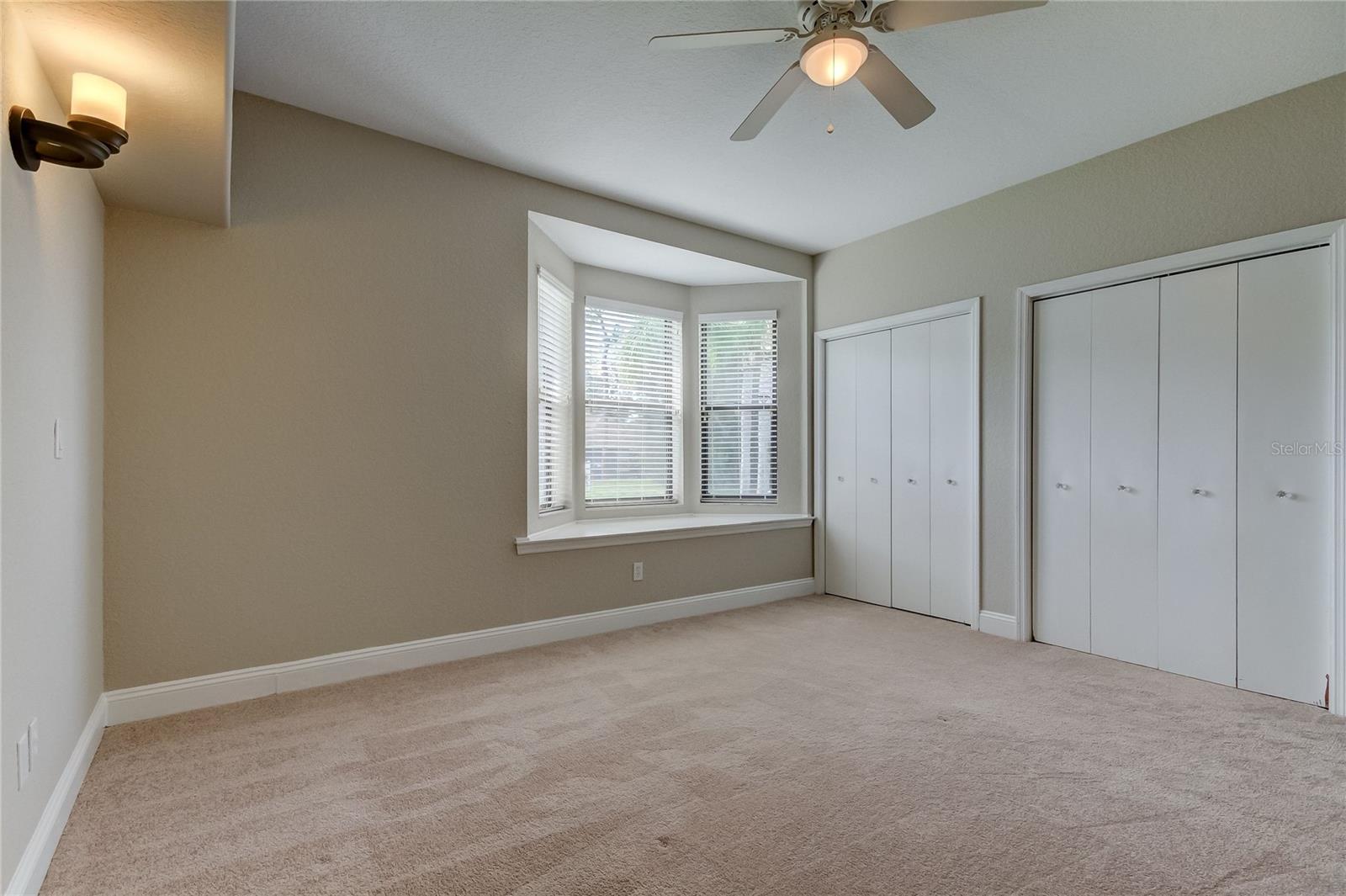 Bedroom 4 with storage under the seating by window, dual closets