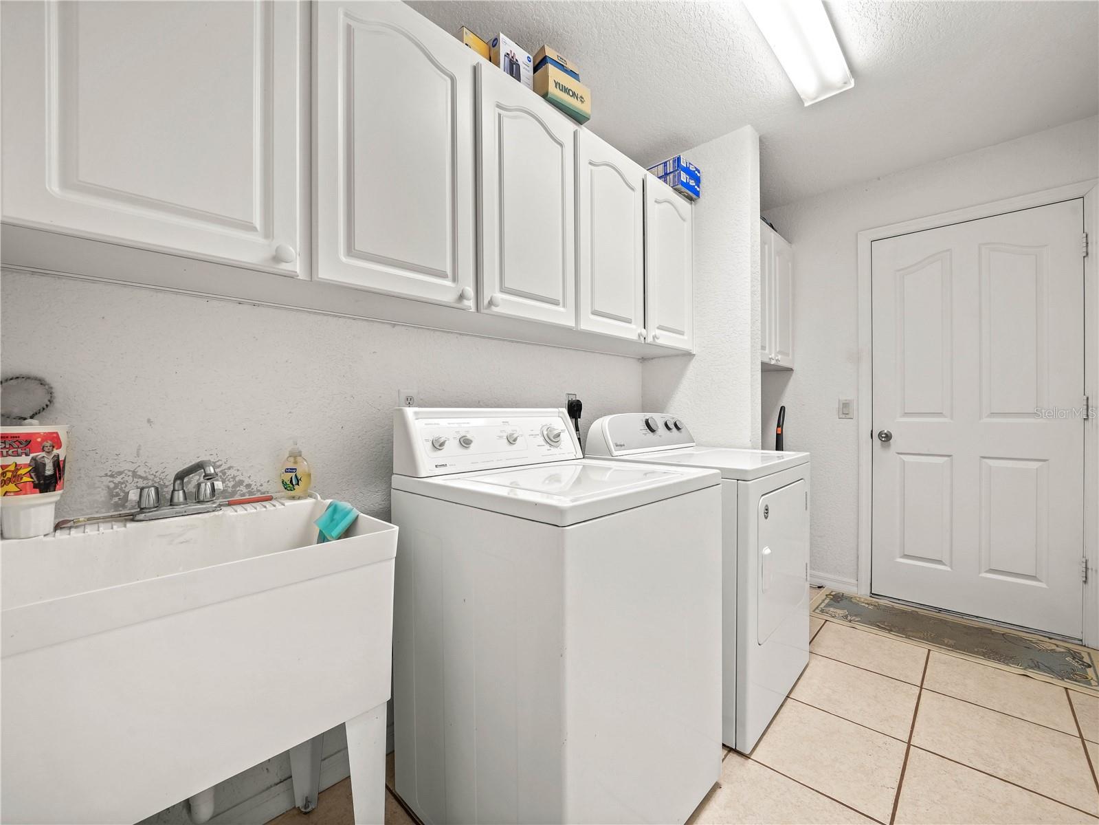 Large interior Laundry w Cabinetry