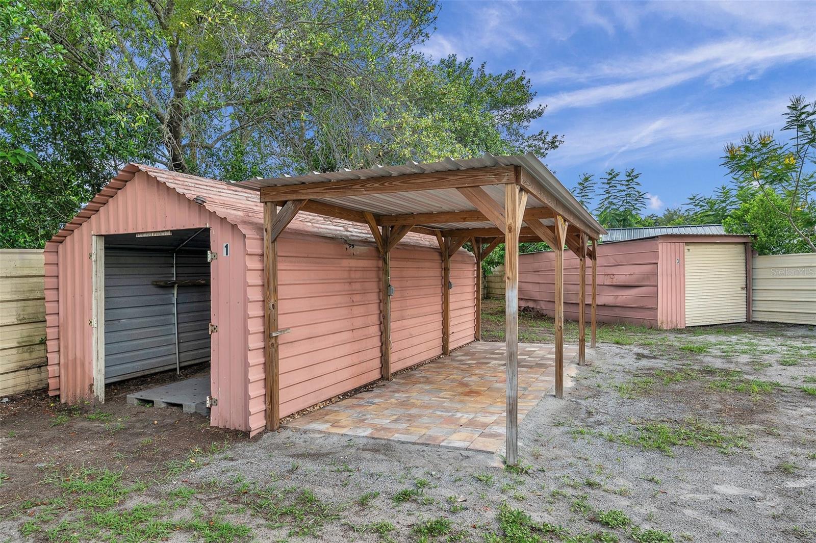 Additional storage with pavers and covered carport