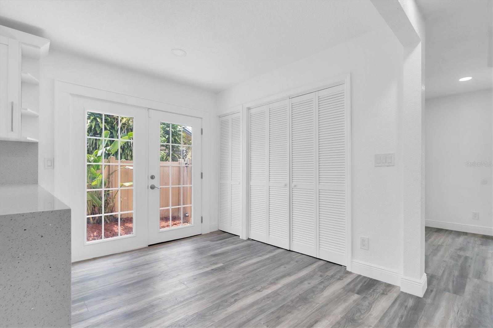 Eating Area in Kitchen Featuring Closet Doors Which Open To Washer/Dryer Hookups and Tankless Hot Water Heater.  French Doors Lead To A Private Outside Walkway.