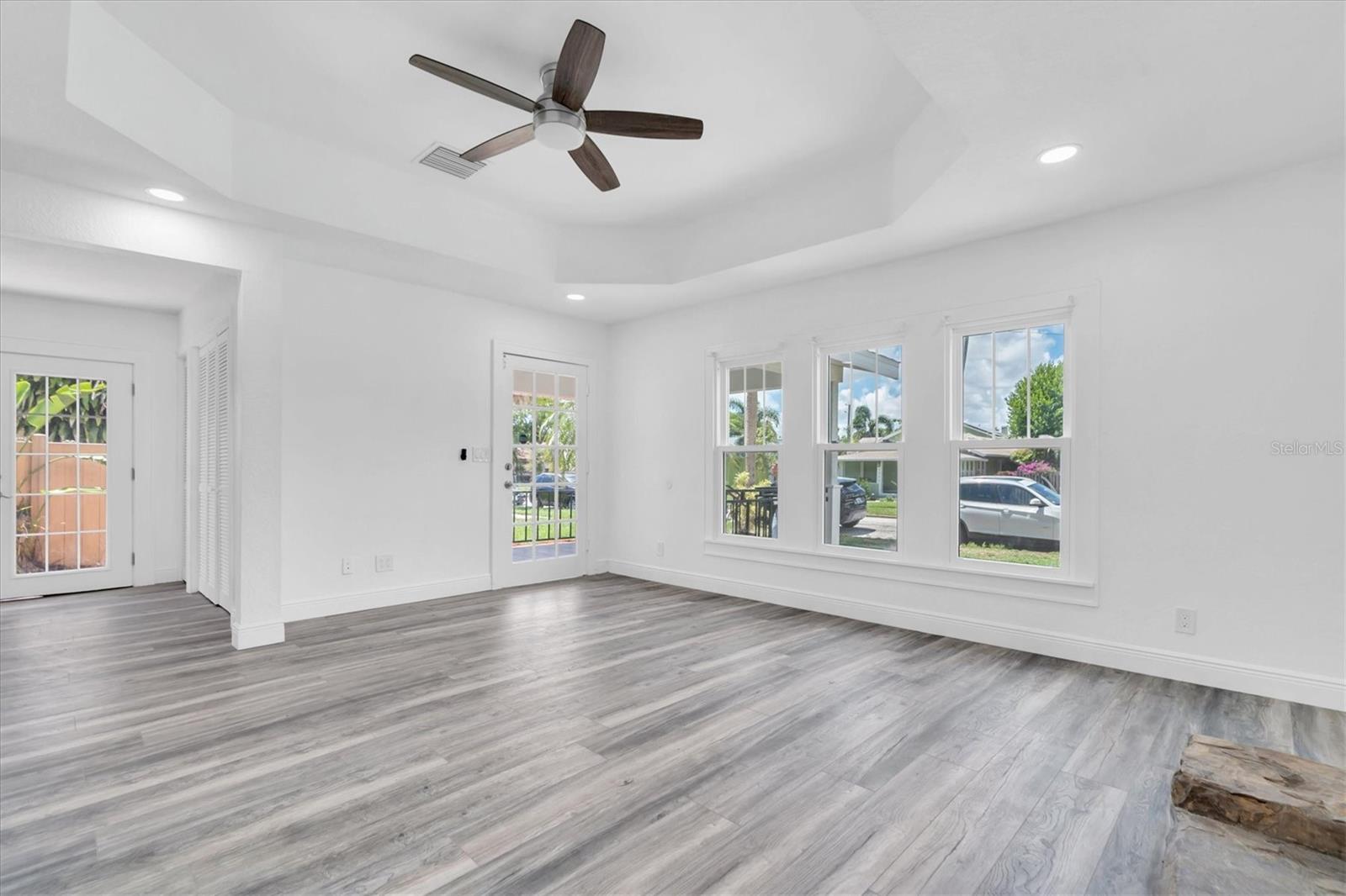 Living Room Facing Front Door and Side French Doors