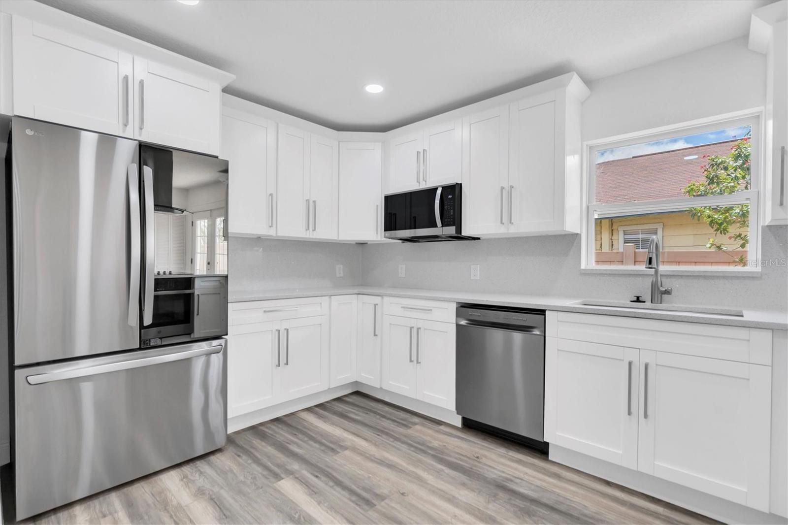 Kitchen with New Appliances Featuring a Smart Refrigerator.