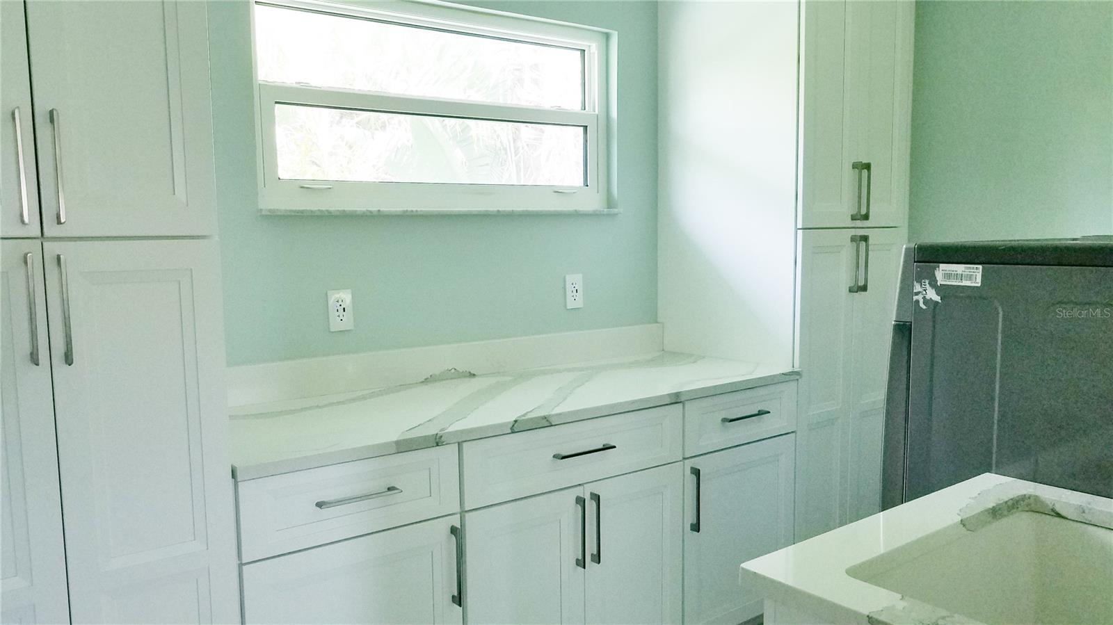 Laundry room with lots of cabinets for storage