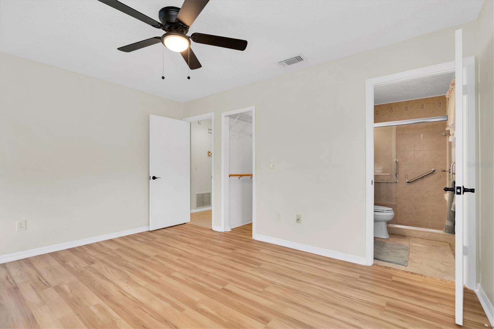 Primary Bedroom Looking into Walk-In Closet and Ensuite