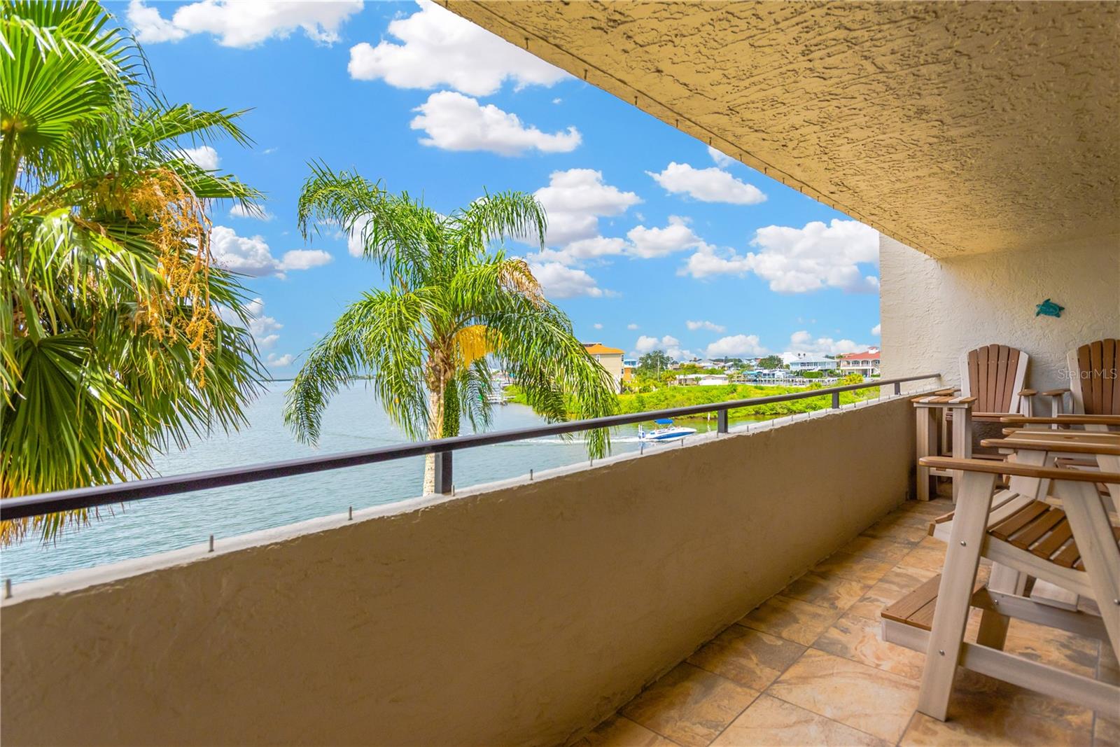 Spacious private balcony boasts an amazing view from every angle.  Watch the boats go by as they enter and exit the neighboring canal.