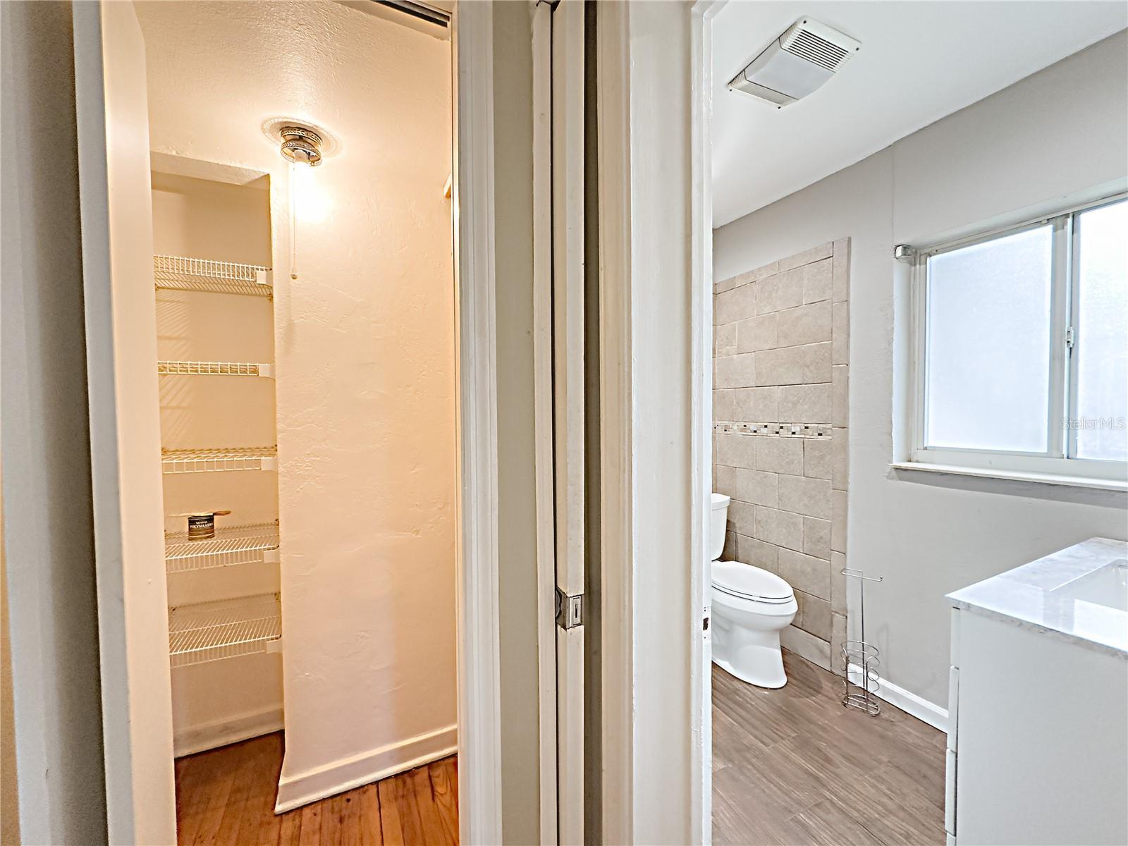 Master bath with view of linen closet