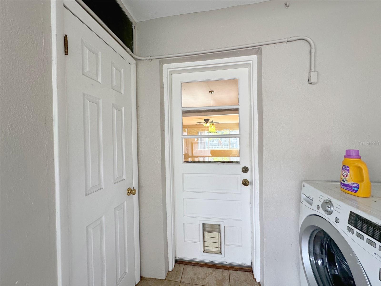 View of rear entrance to home with door to 1/2 bath on the left