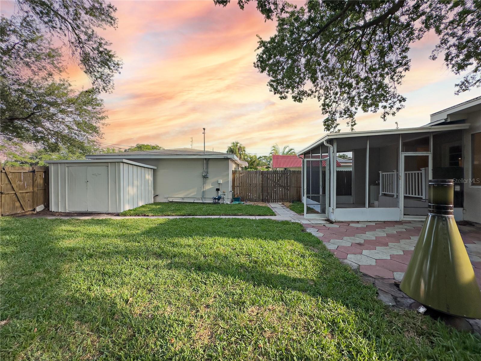 View of huge back yard, sunroom and on the left is the ADU!