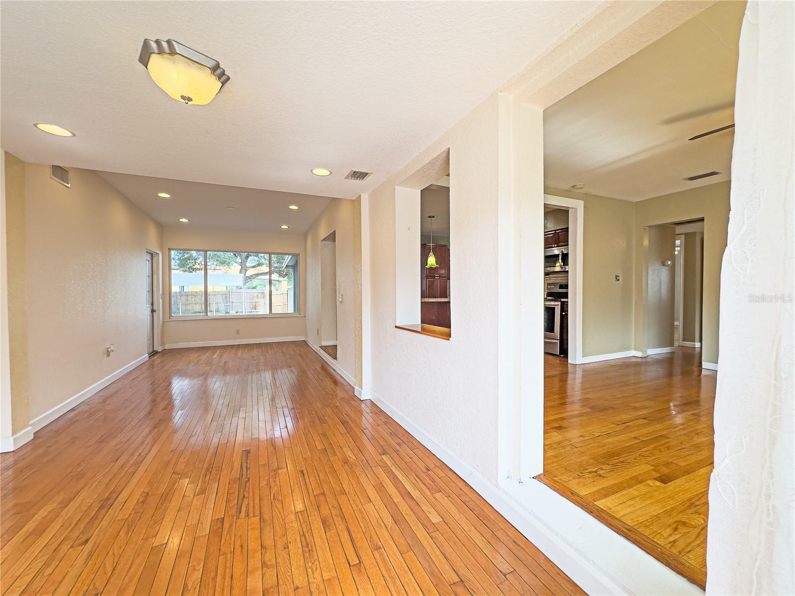 View upon entering the main home. The great room and to the right the living room with a view of the kitchen and the bedrooms entrances to the right