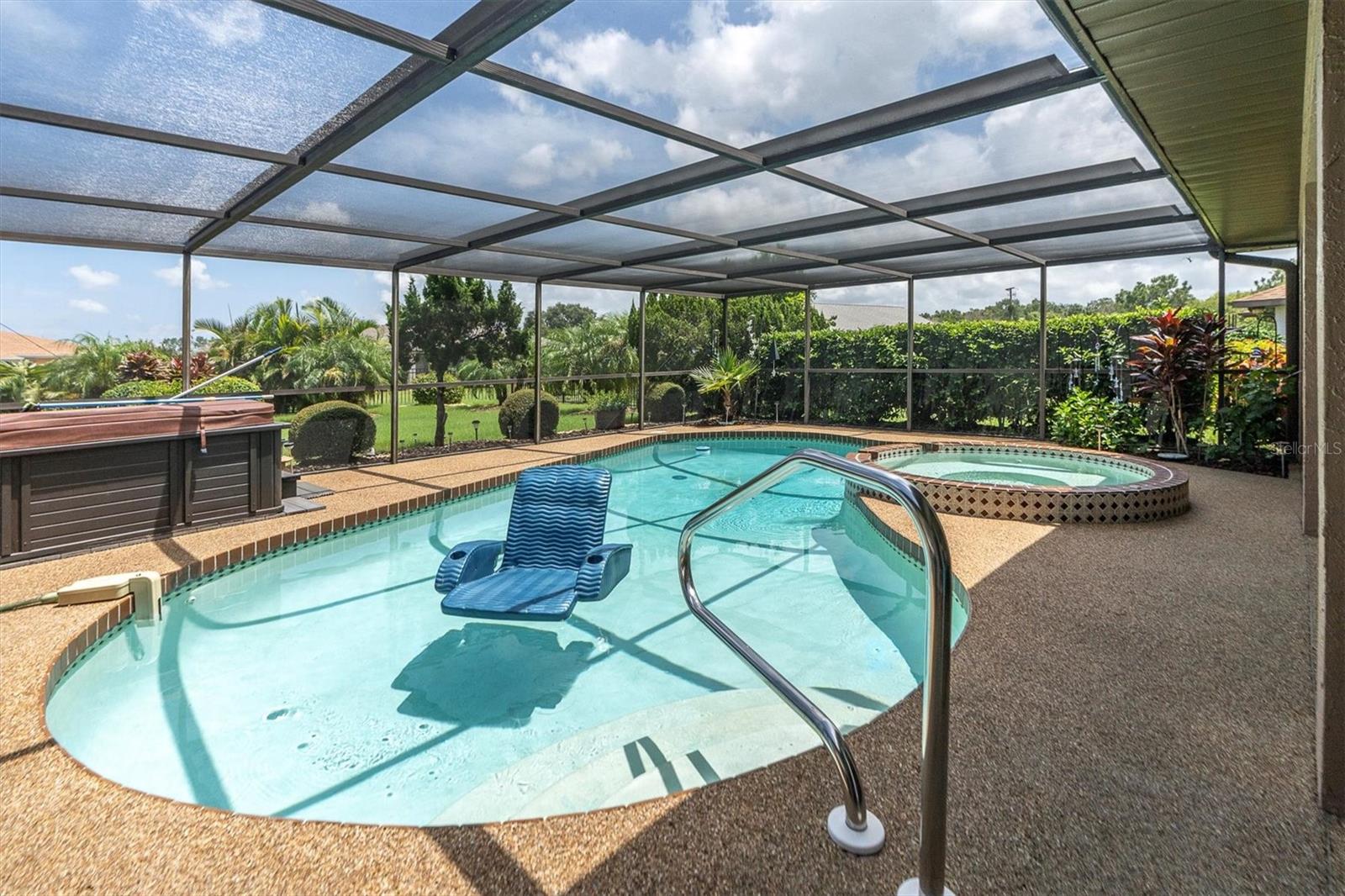 Pebble deck screened in pool