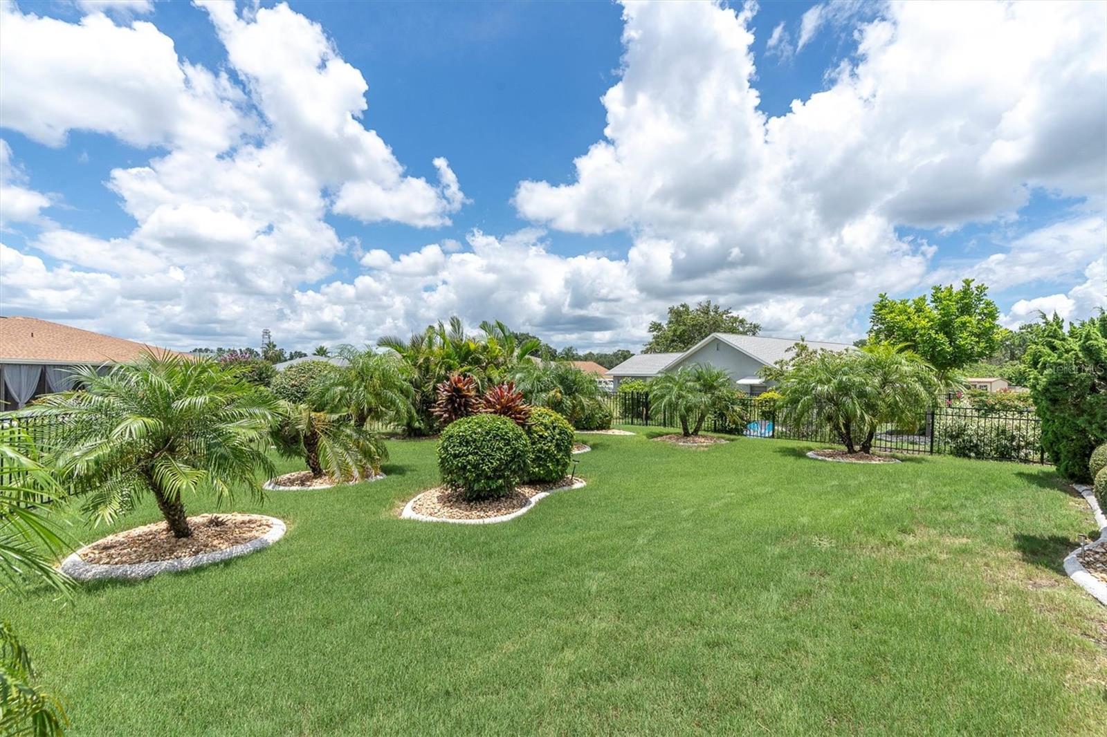 Fenced in backyard with beautiful landscaping