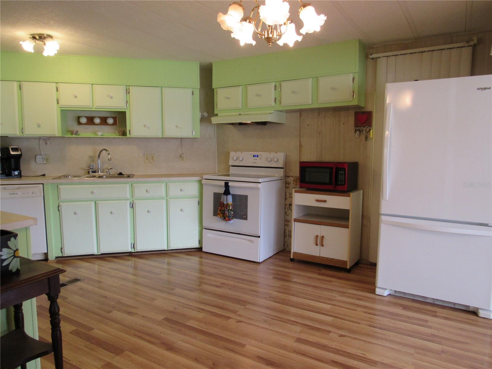 Spacious eat-in kitchen with laminate flooring.