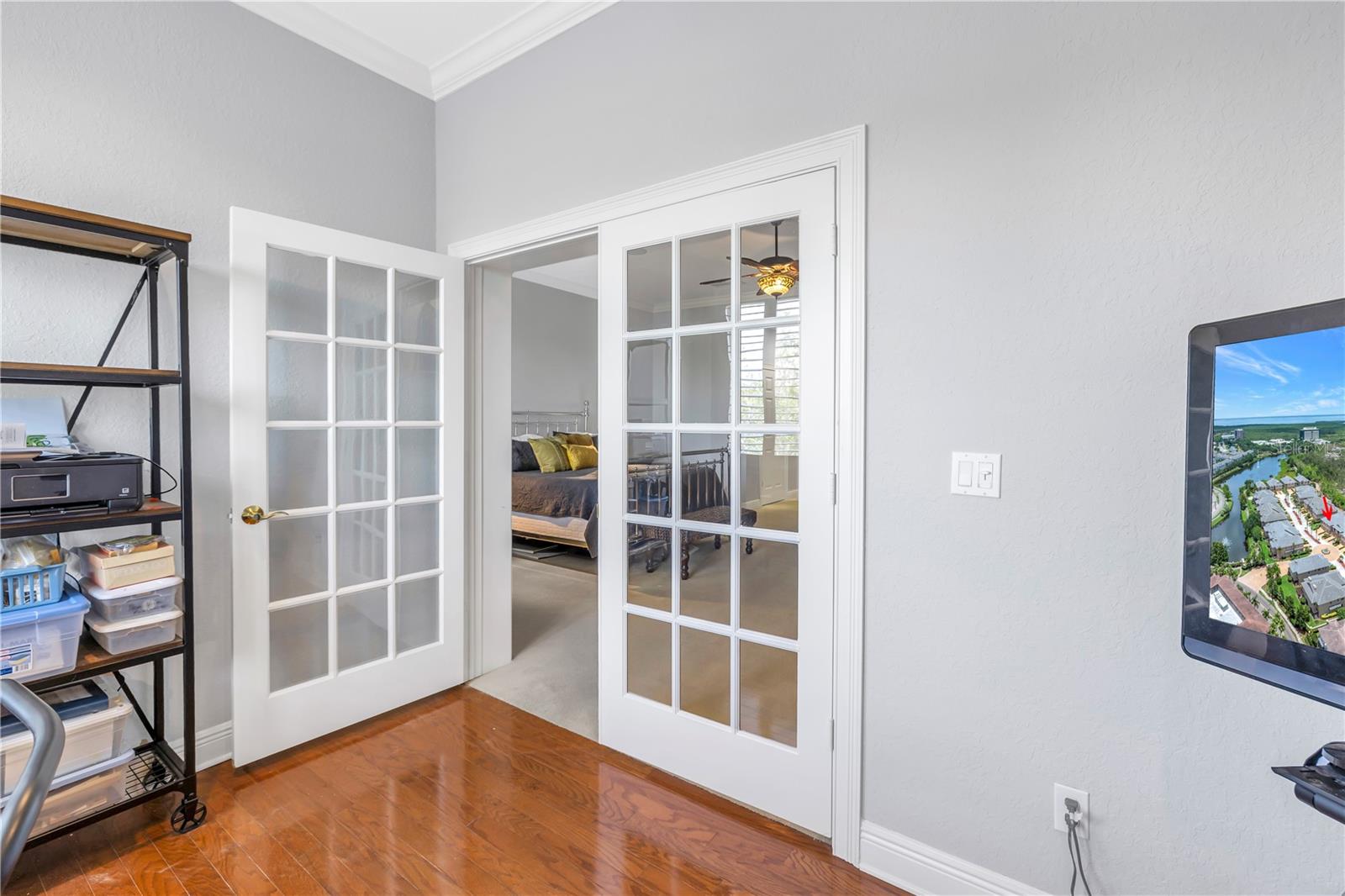 French doors separate the office from the bedroom space