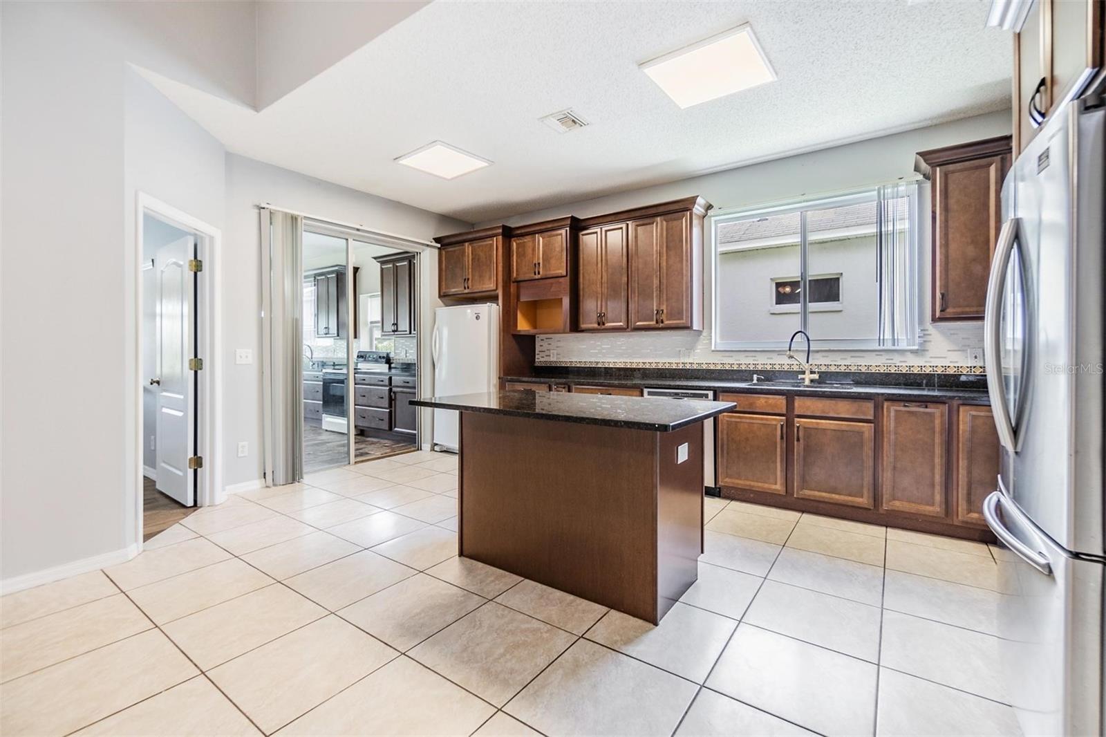 Inside kitchen, tile flooring and granite countertops.