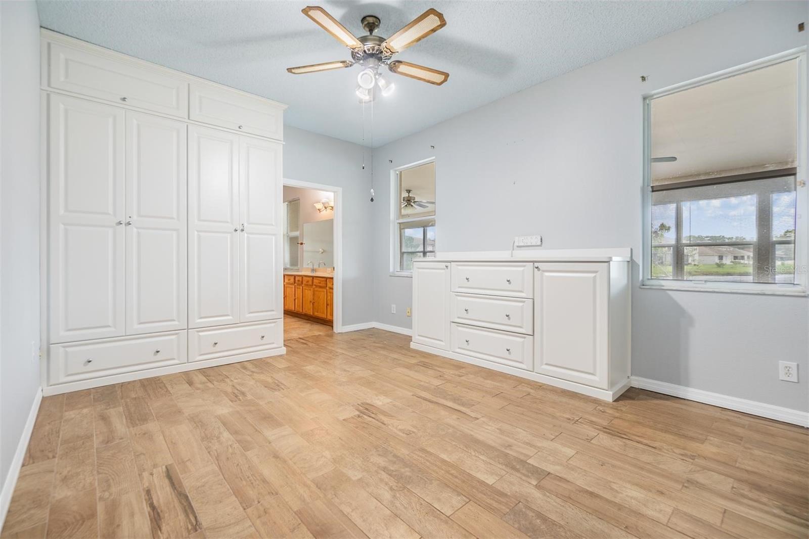 Master Bedroom Downstairs, Wood Flooring, Ceiling fan, new paint, and built ins.