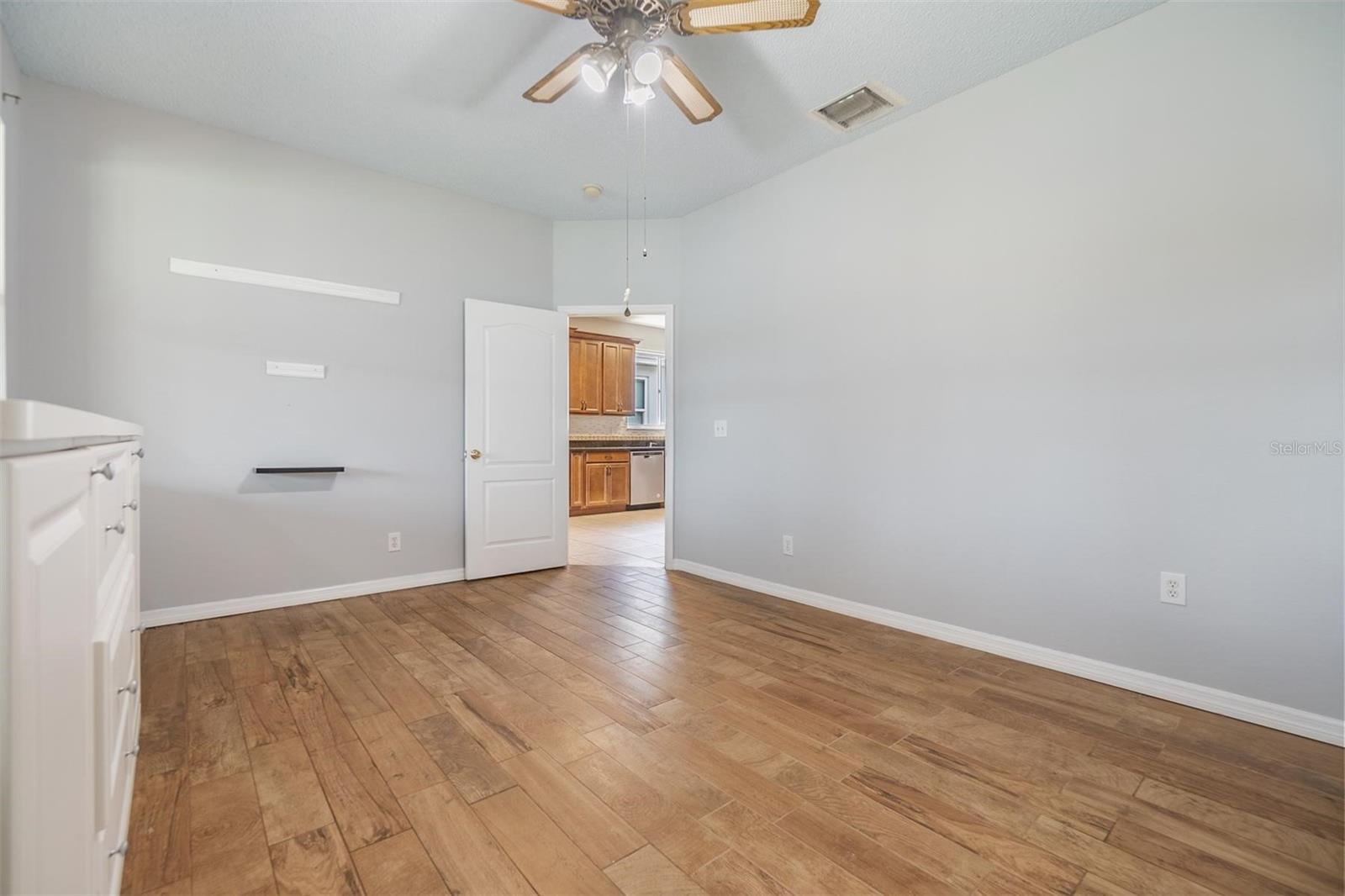 Master Bedroom Downstairs, Wood Flooring, Ceiling fan, new paint.