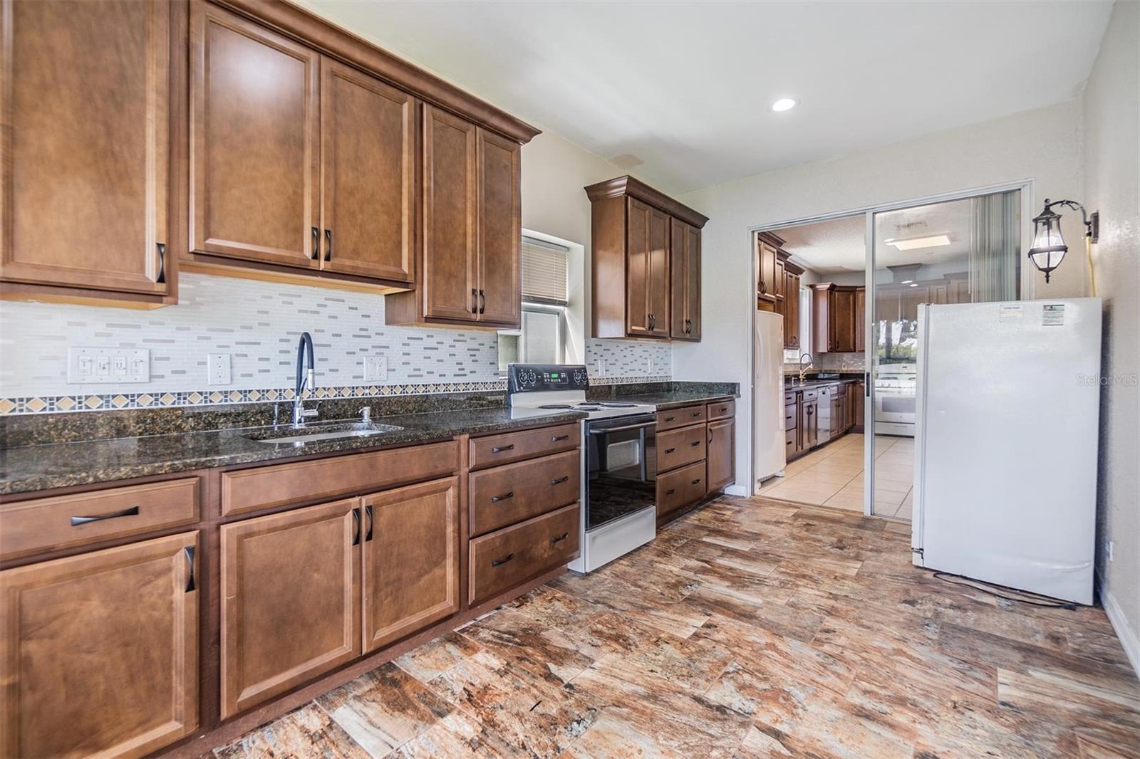 Patio Kitchen, tile flooring, Granite countertops.