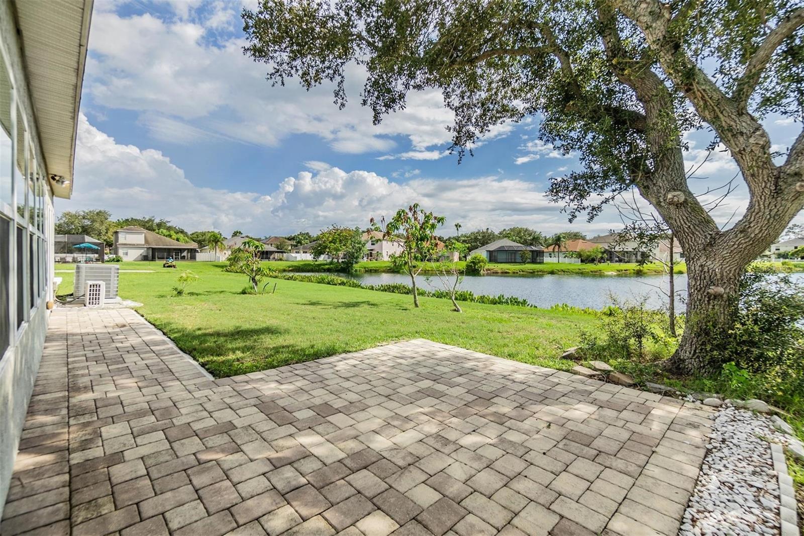 Rear Exterior - Gorgeous pond view - Pavered open patio