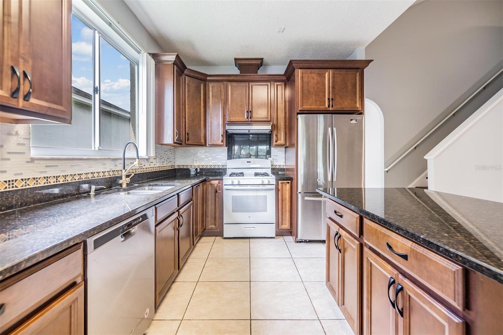 Inside kitchen, tile flooring and granite countertops.