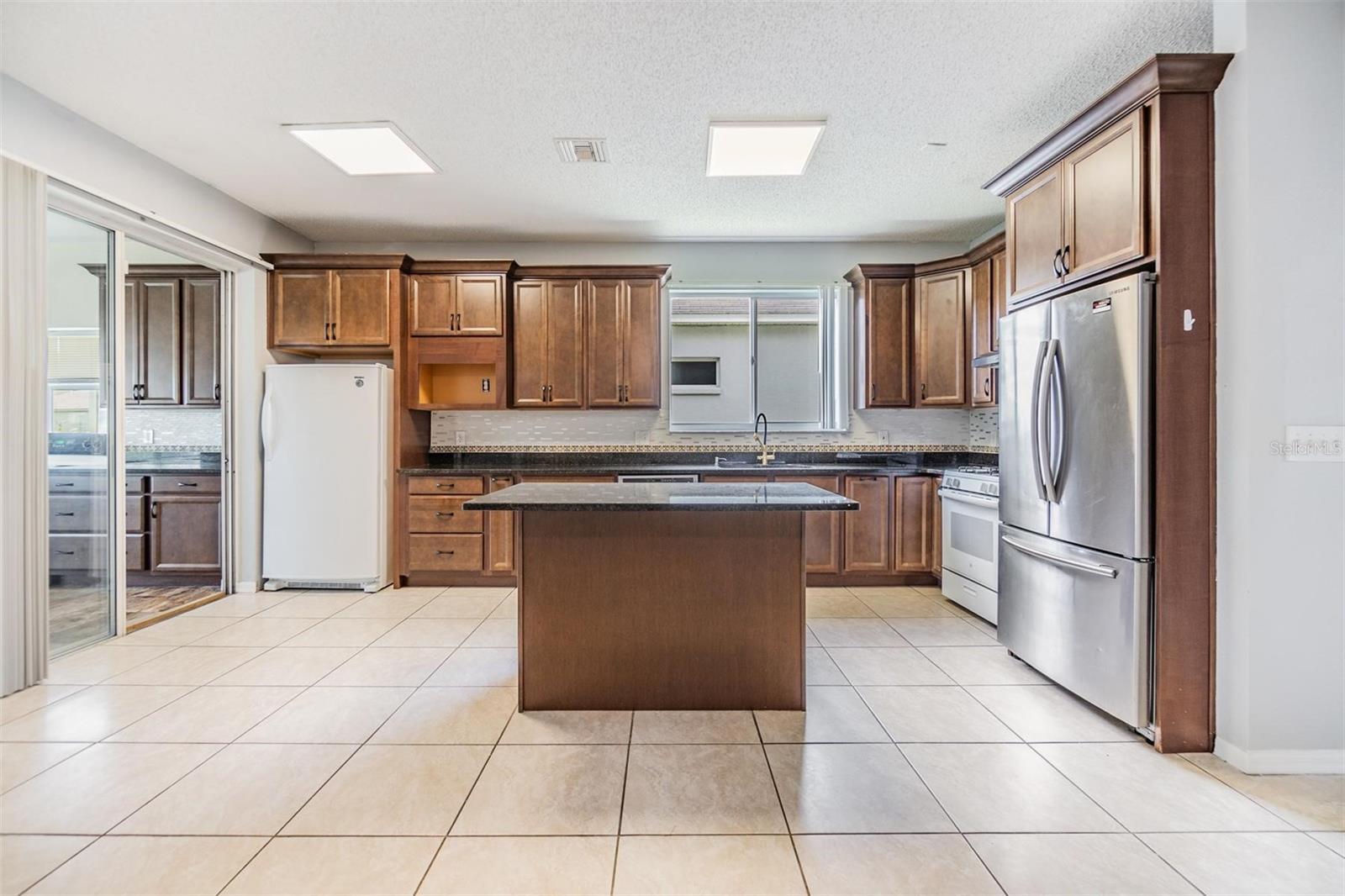 Inside kitchen, tile flooring and granite countertops.