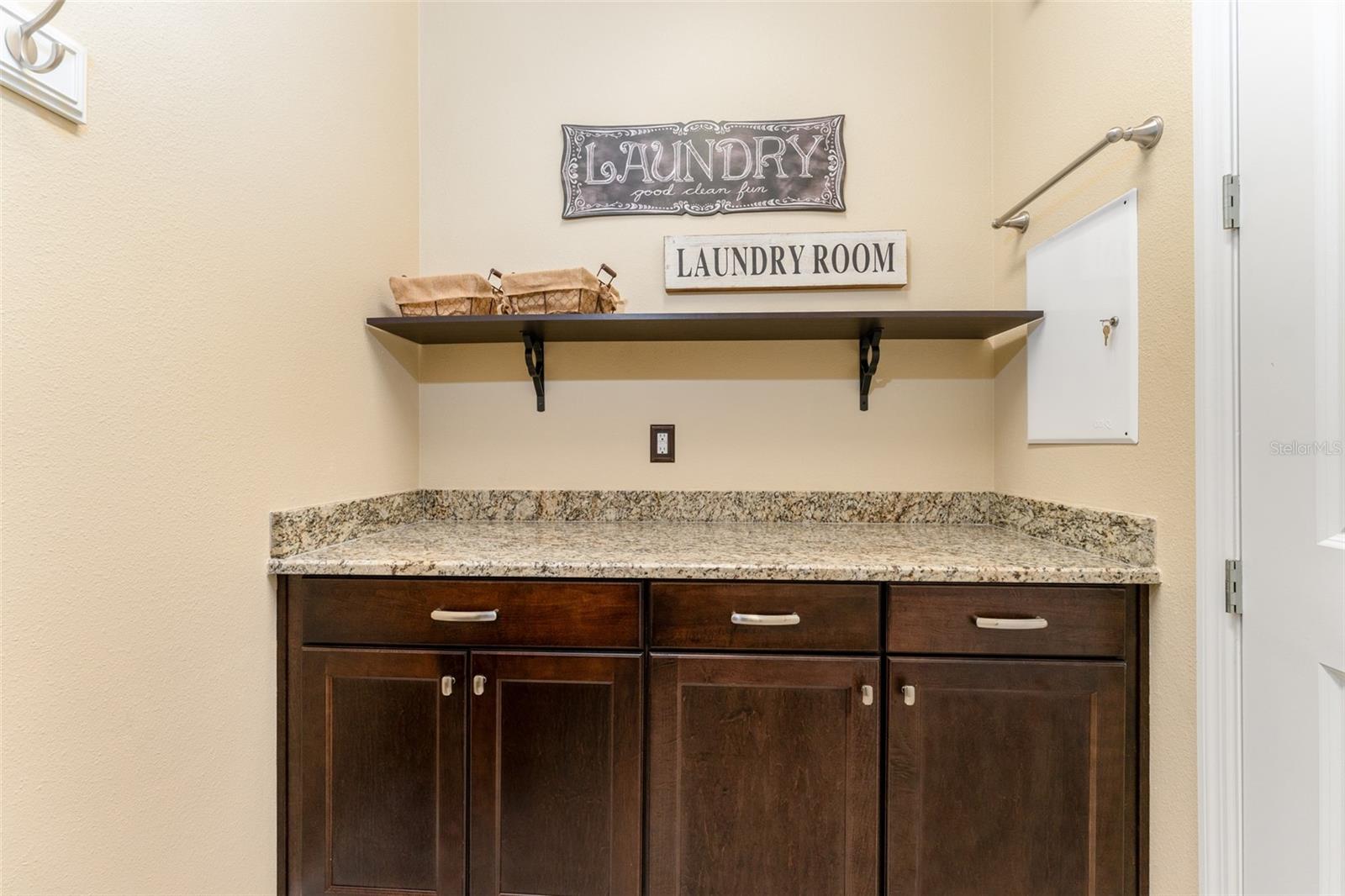 Laundry Room with Built-in Cabinets and Granite Top -Folding Table