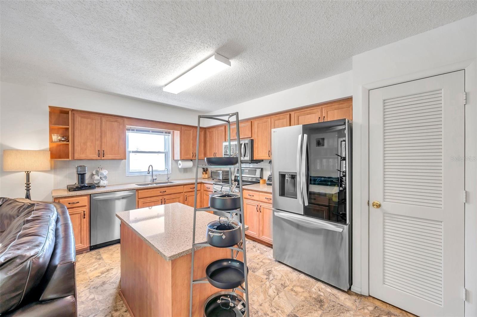 Kitchen opens to living space with plenty of natural light