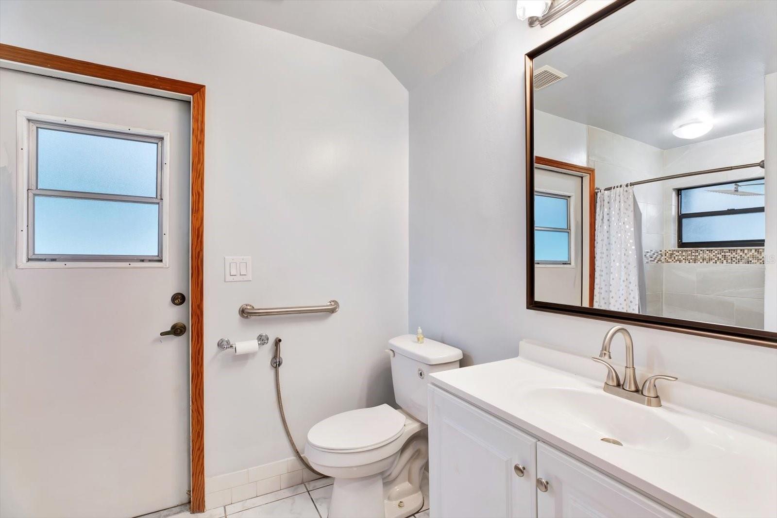 Main Bath with a door to the pool deck.