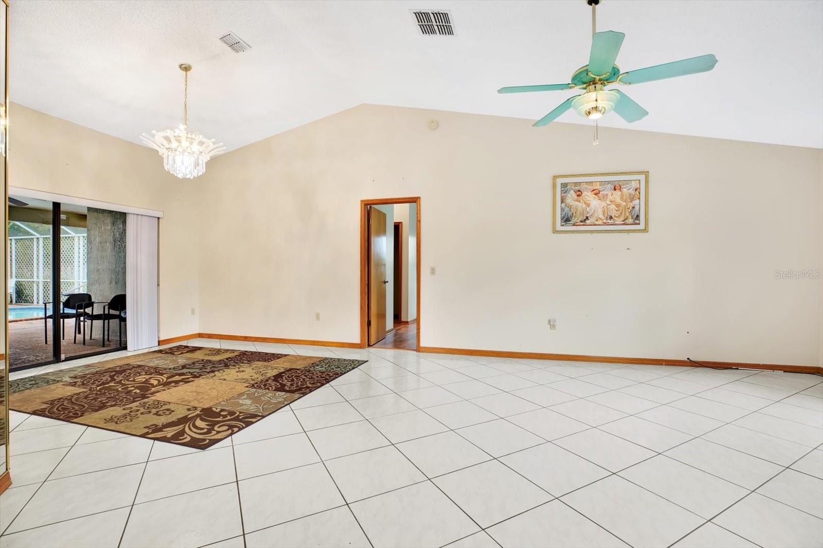 Open Living Room - Formal Dining Room with tile floor, vaulted ceiling.