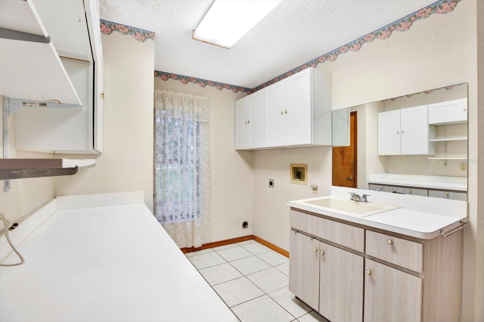 B-I-G Laundry room w/ WA/Dryer hookups; utility sink, closet, folding counter with 2 double under cabinets + 1 overhead.