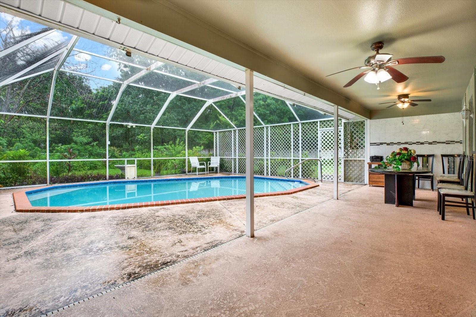 Spacious Covered Patio w/Buffet styled serving shelf, room for Barbeque & plenty of seating space.