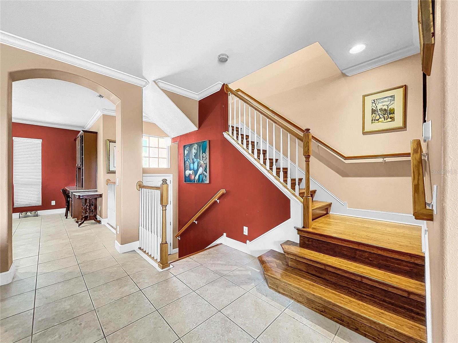 Open foyer area and beautiful wood staircase.