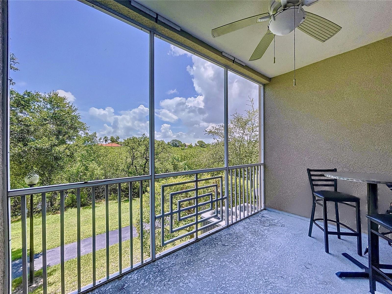 Screened balcony with views of the bayou.