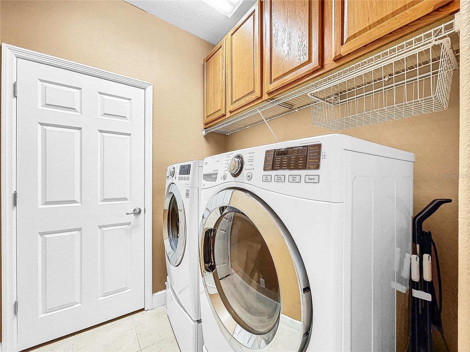 Upstairs laundry with ample storage.