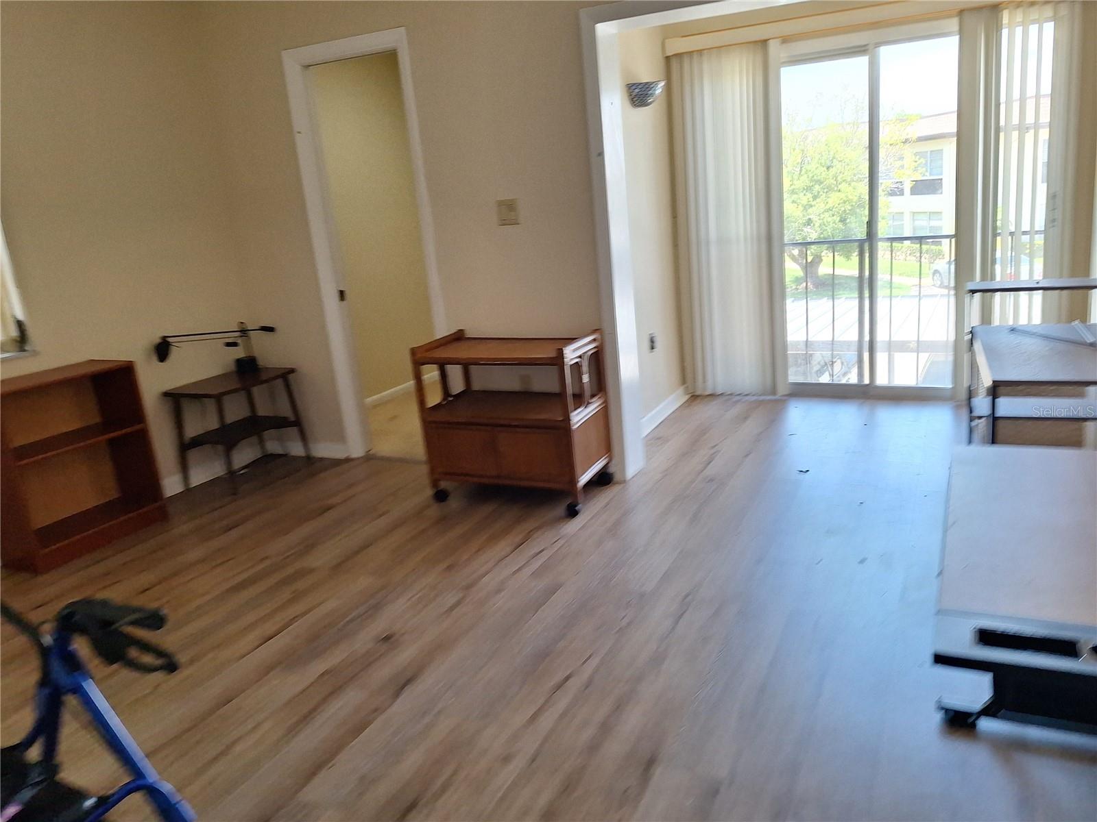 Bedroom 2 with walk in closet and sliders.