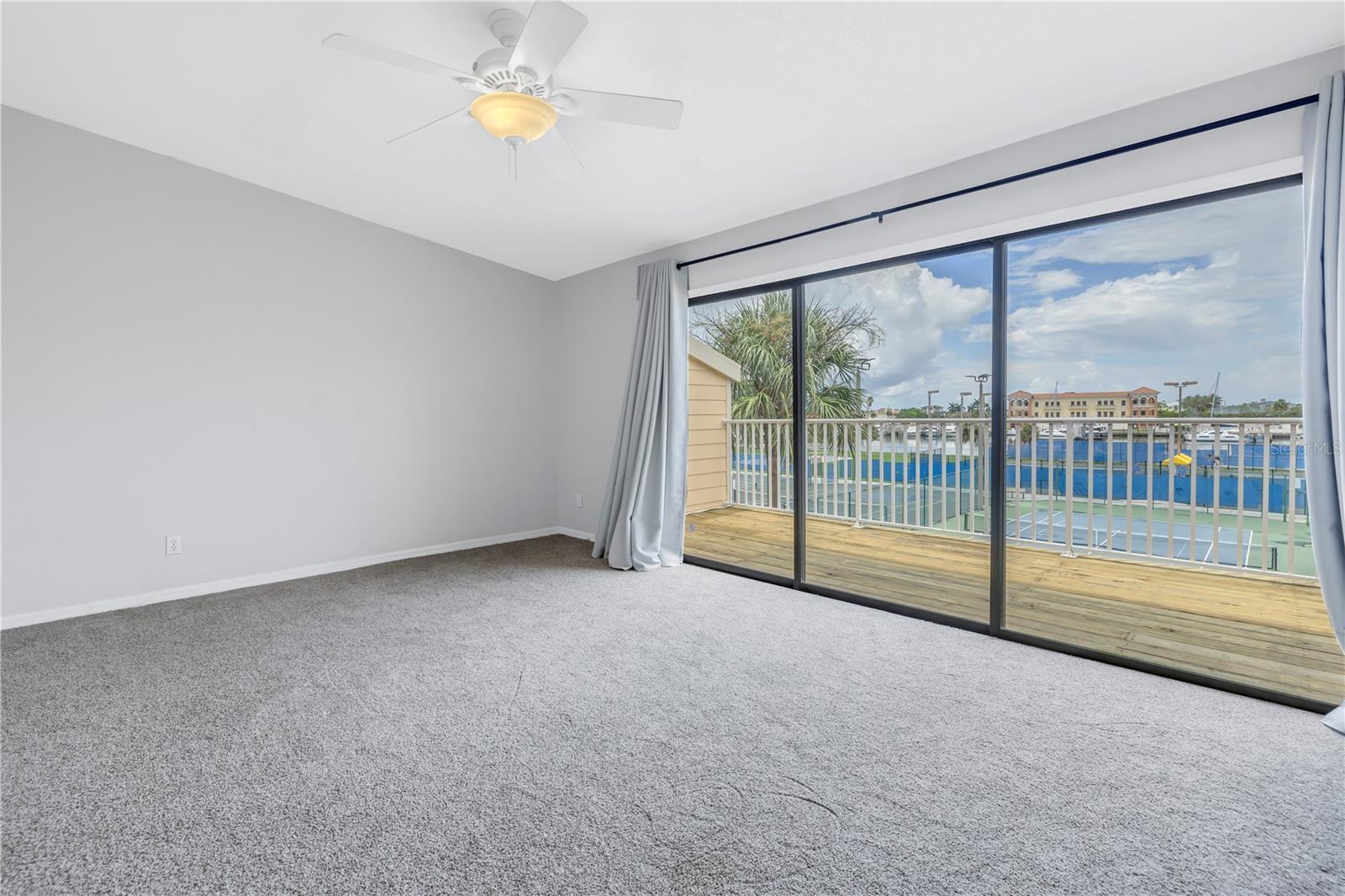 Primary bedroom with sliding glass doors leads to deck.