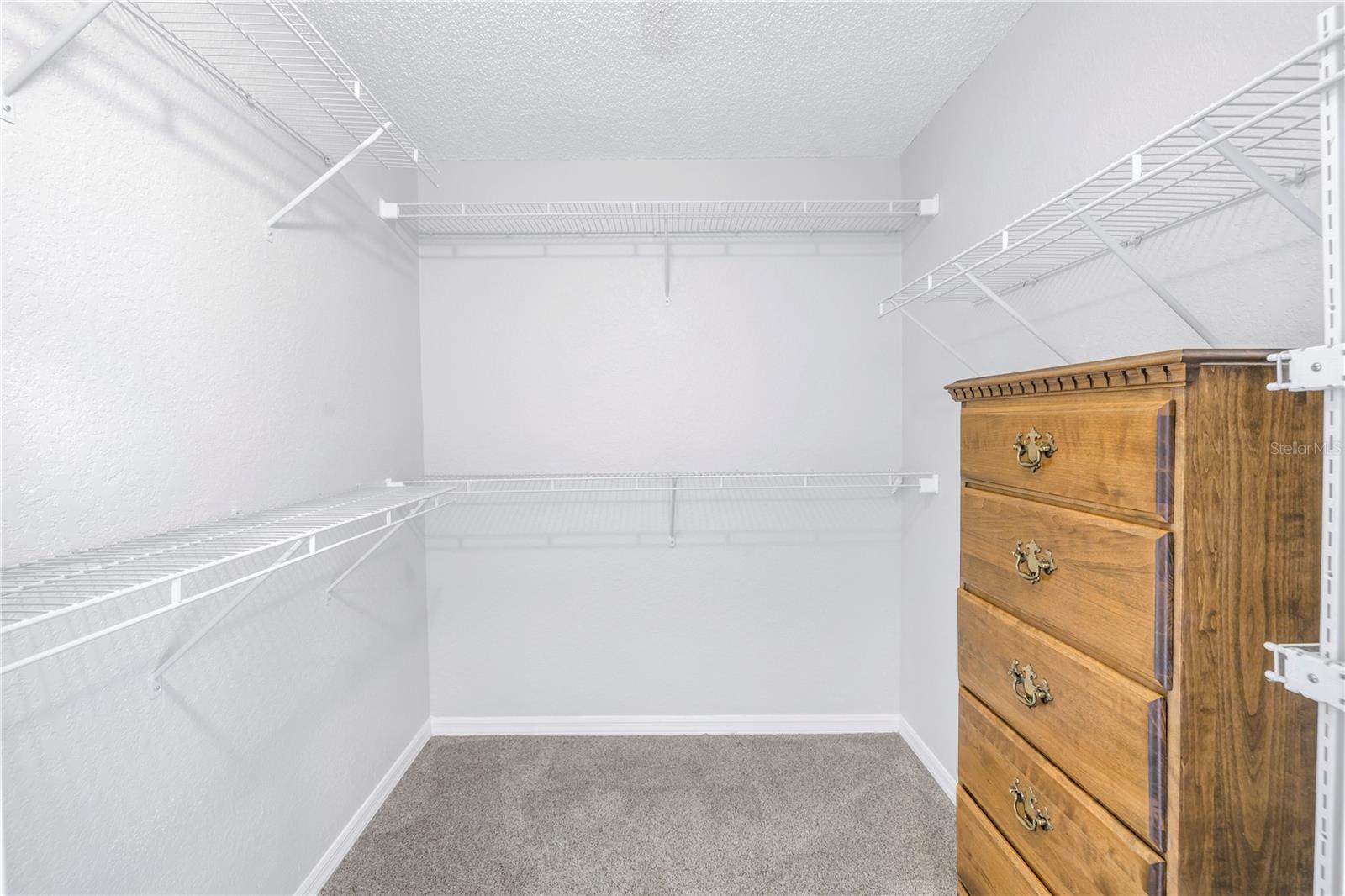 Walk-in primary closet.