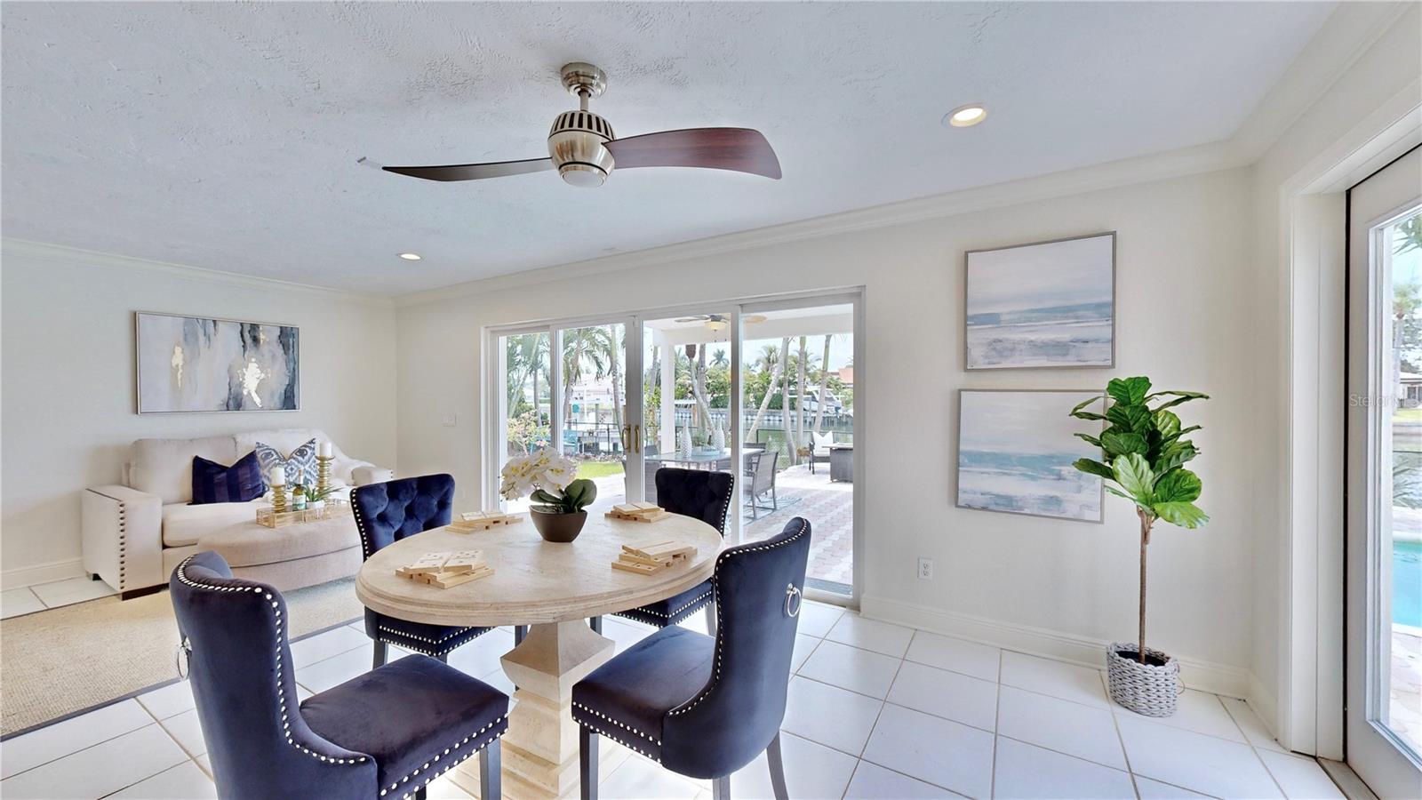 Serene waterfront & pool views from dining room/ living room.