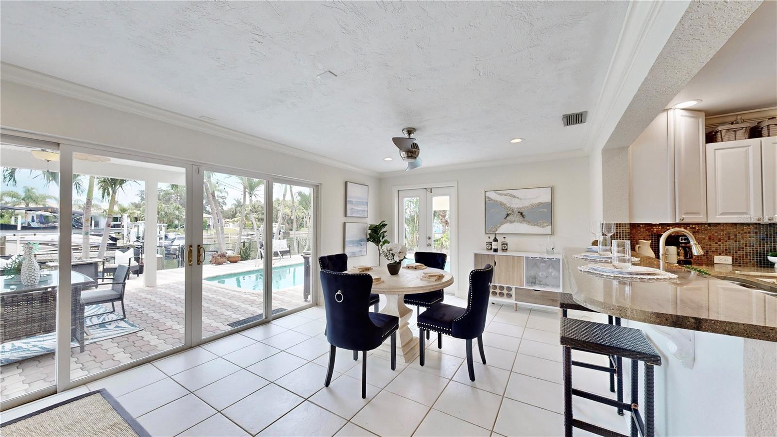 Breakfast nook overlooking pool and waterfront.