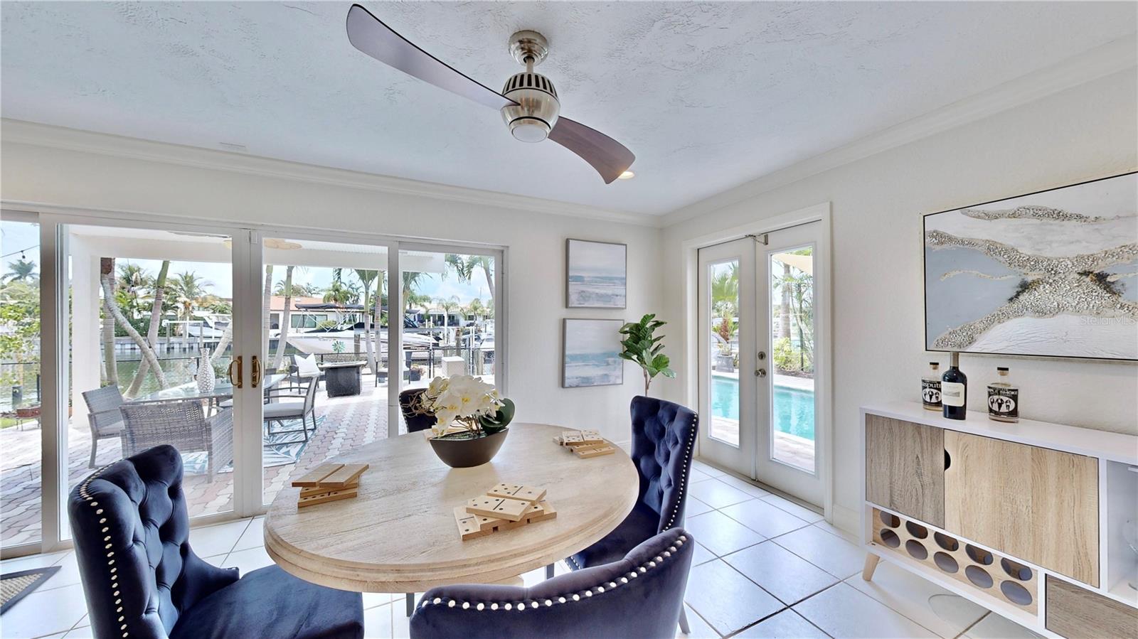 Serene waterfront & pool views from dining room/ living room.