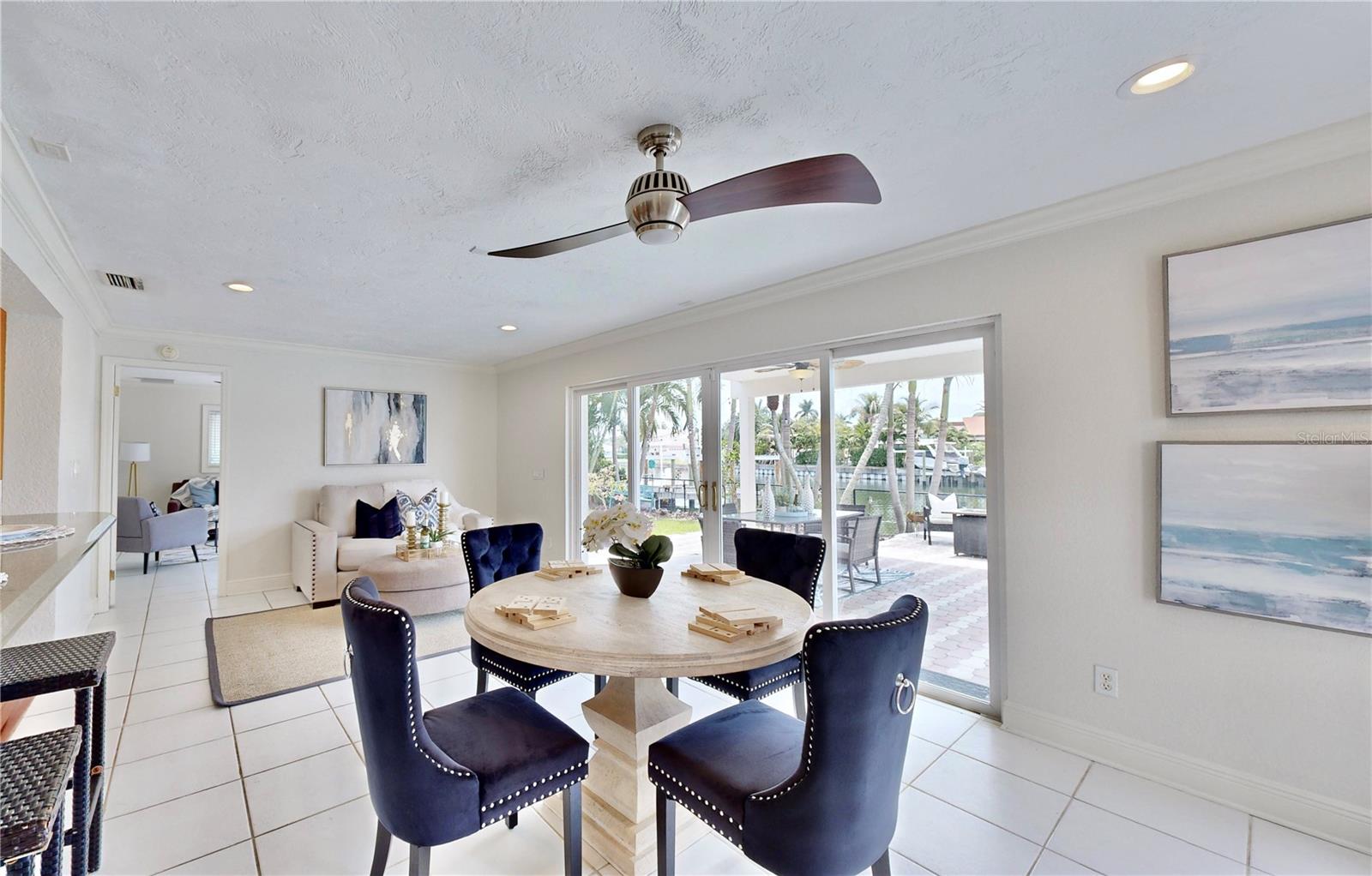 Serene waterfront & pool views from dining room/ living room.