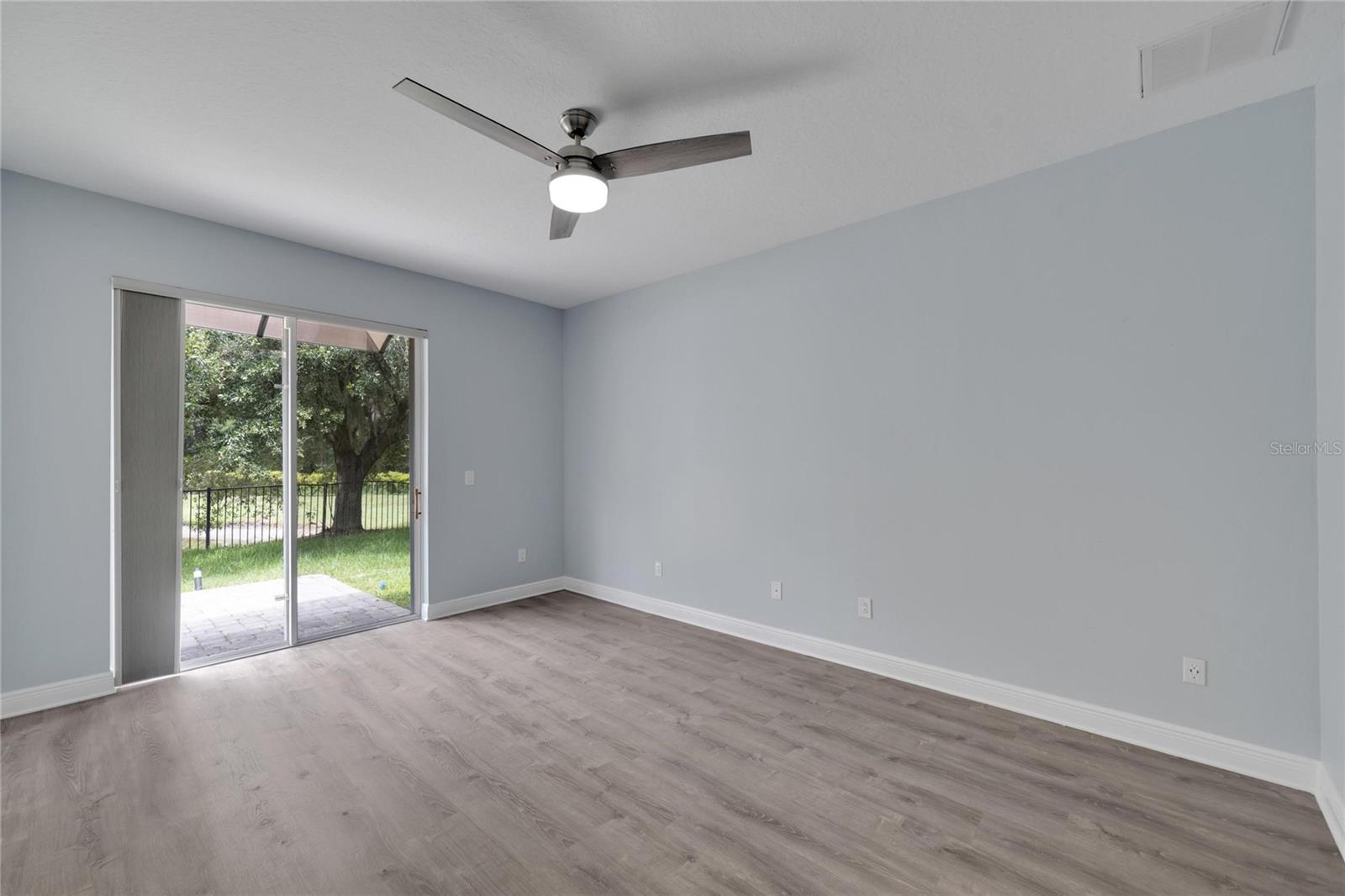 Primary bedroom with backyard and pond view