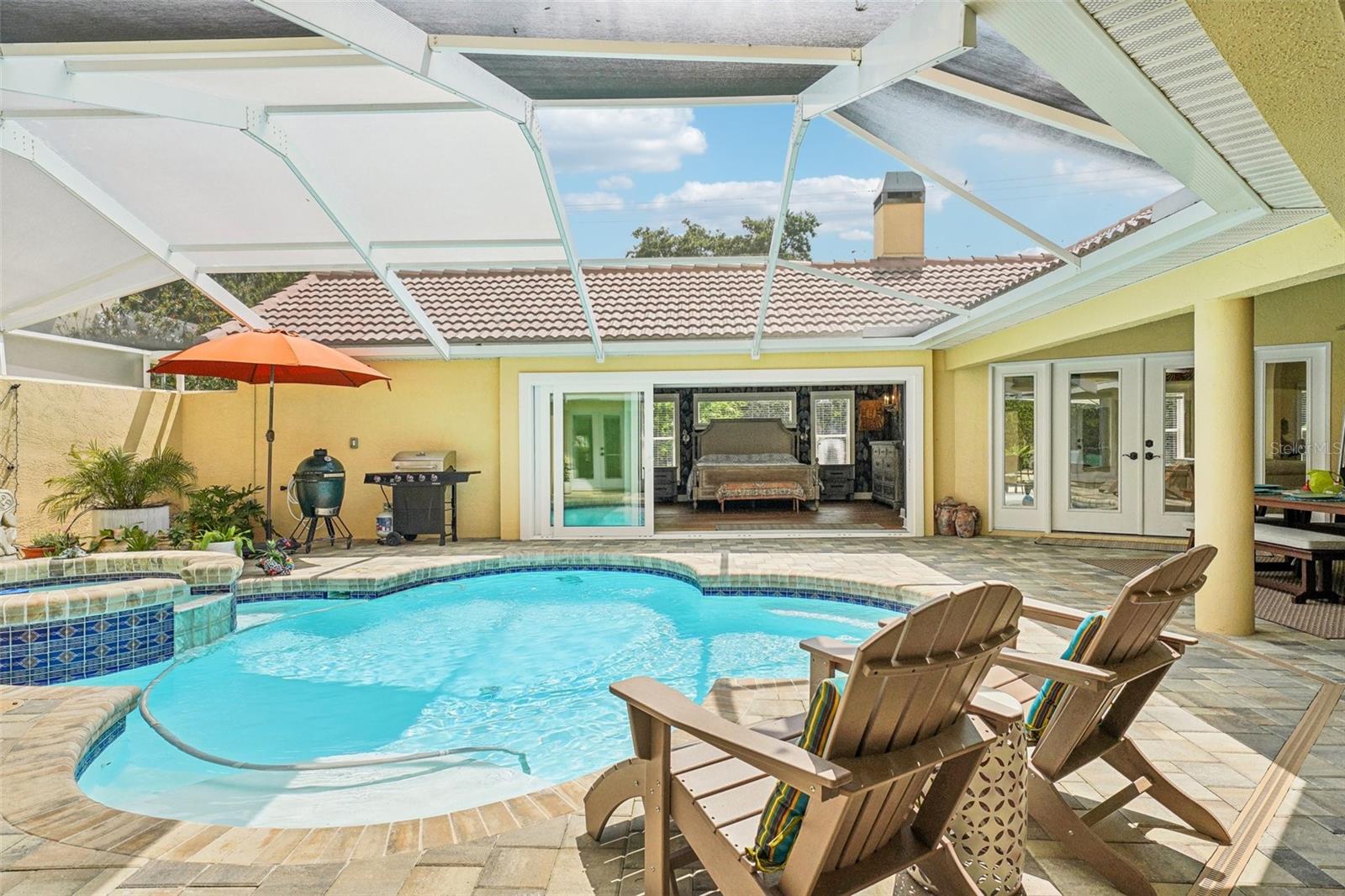 View of the triple sliders to the master bedroom from the pool area