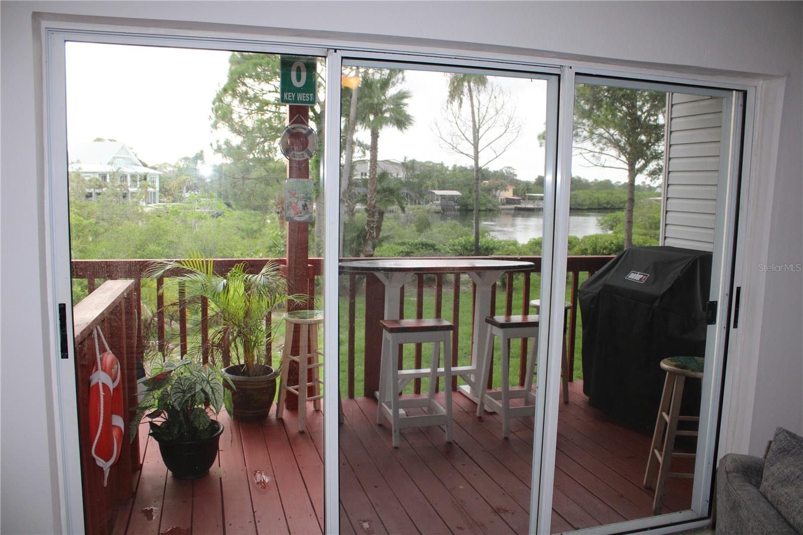 Living room view and Second-floor deck with stair access.