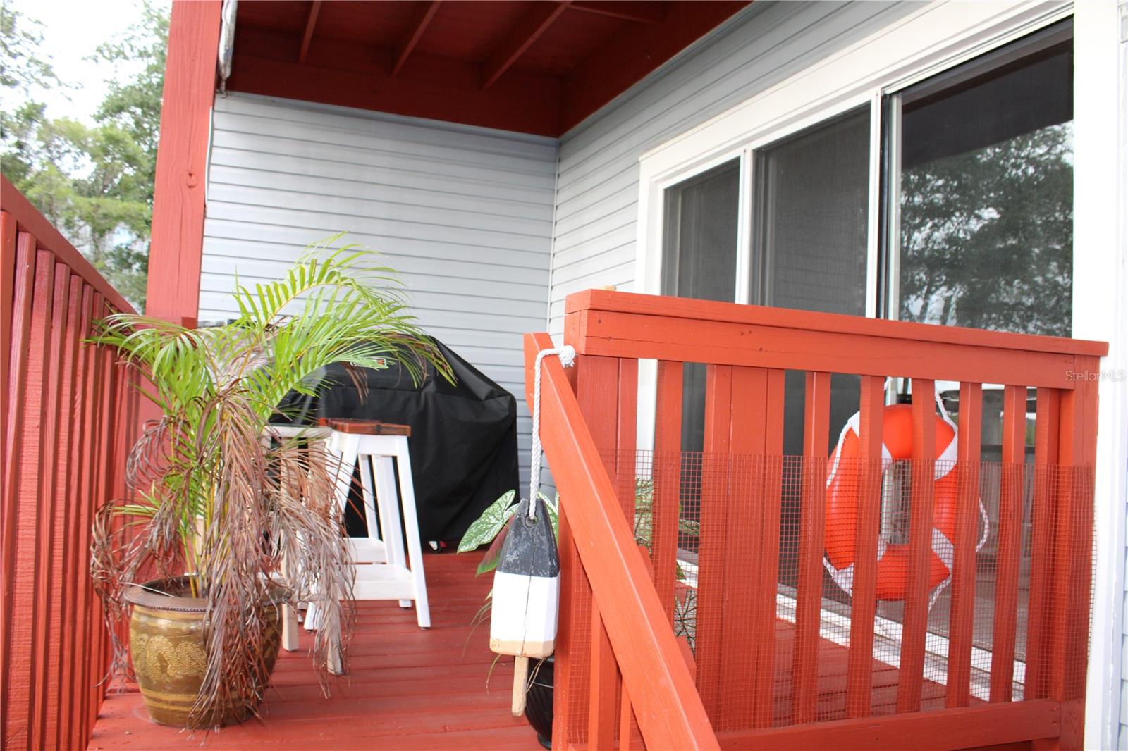 Second-floor deck with stair access.