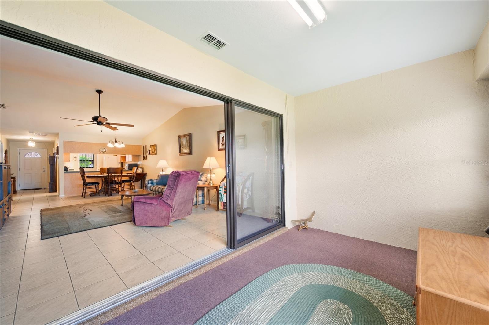 The Florida Room has sliding pocket doors that open to the living room to expand your living area